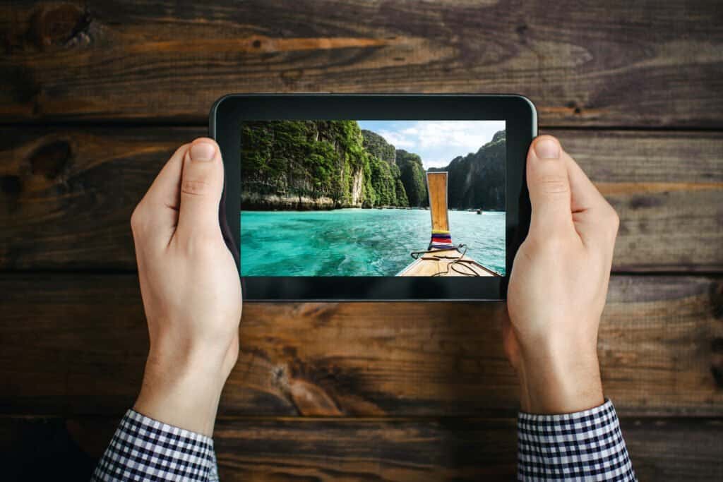 Internet surfing for exotic vacations on tablet. 