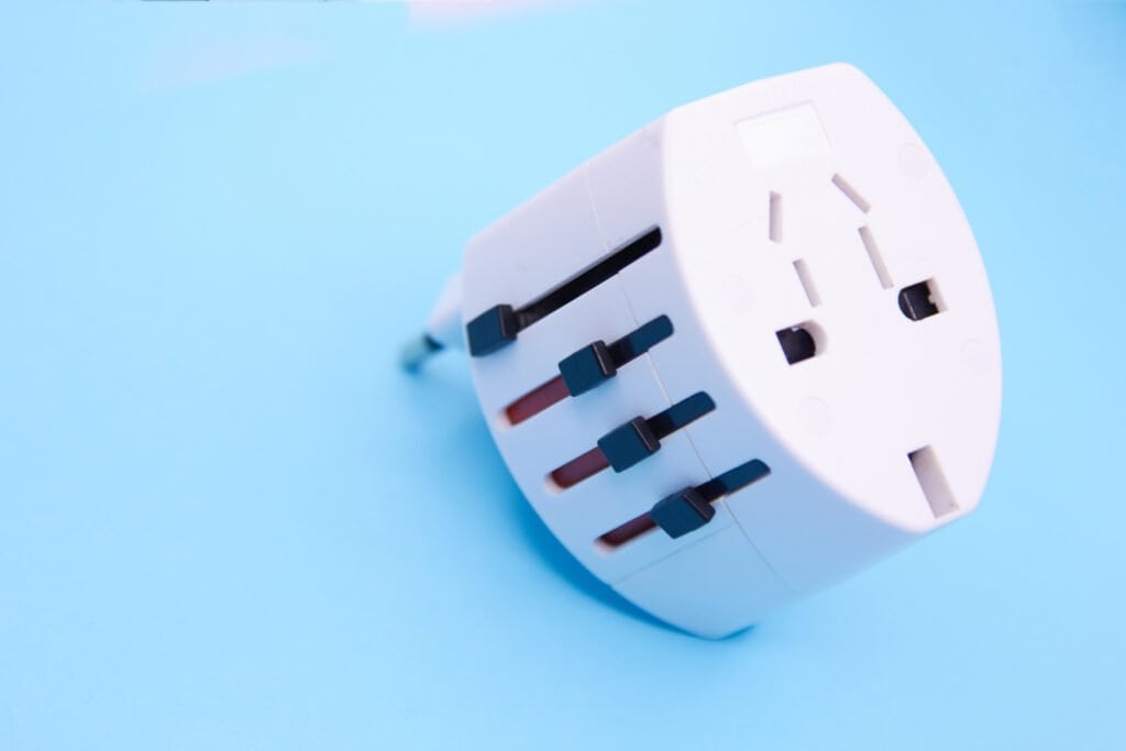 adapter electric adapter multifunctional white on a blue background.