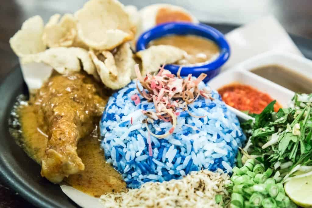 Closeup on Nasi Kerabu with chicken and condiments. Popular traditional Malay food in Malaysia