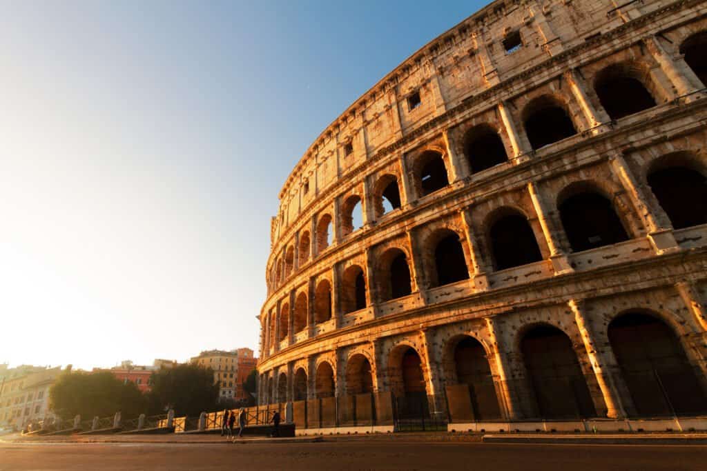 ruins of Colosseum view at sunrise light in Rome, Italy