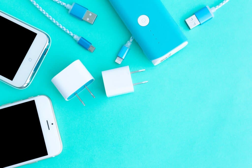 smartphone with adaptor and USB charging cables in top view