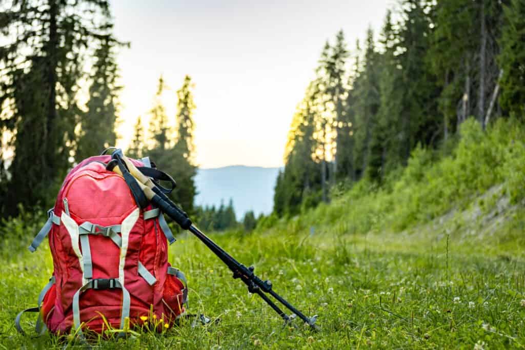 Hiking backpack with trekking poles for mountain hiking.