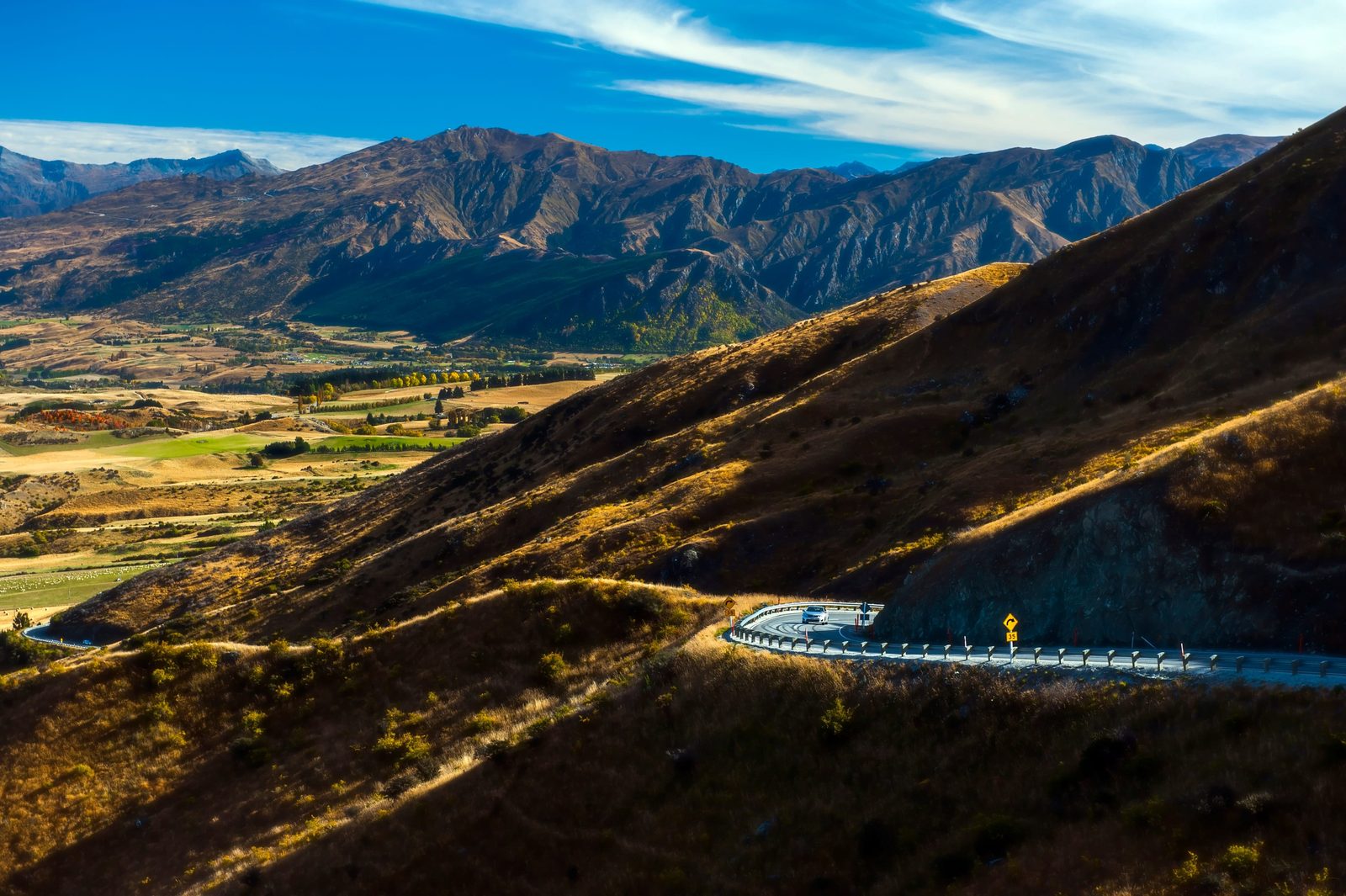 An empty road running through the mountains of New Zealand