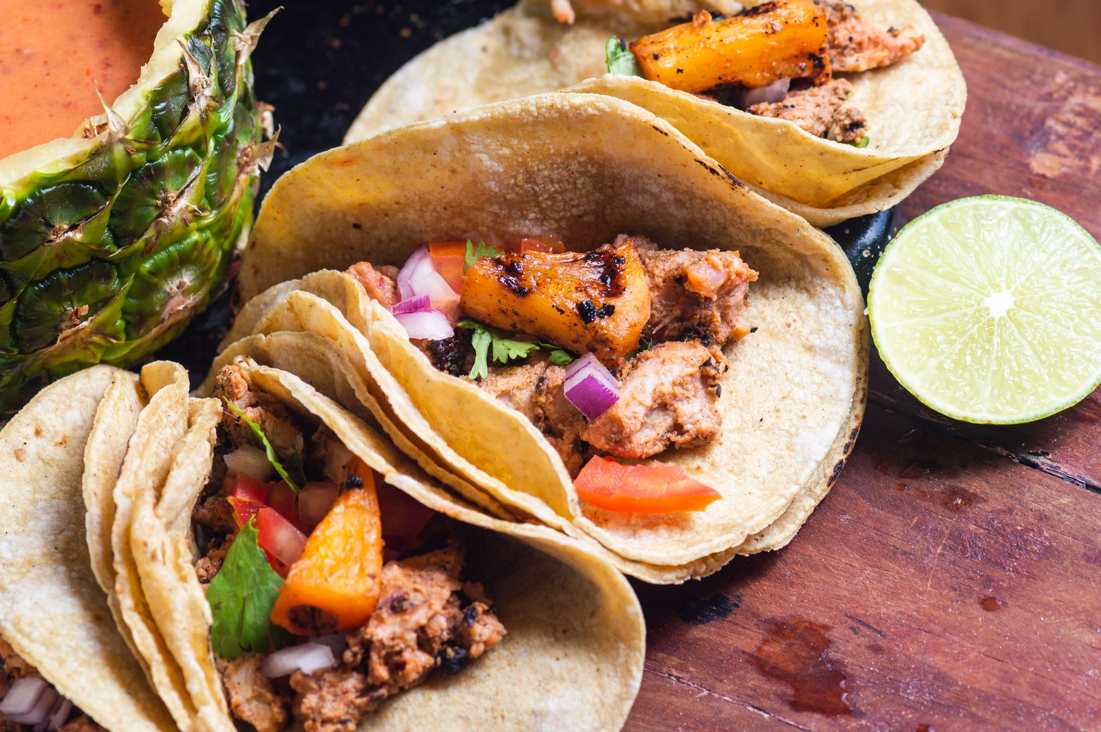 Tacos al pastor with pineapple and salsa, a Mexico City staple