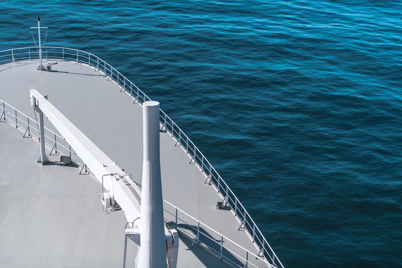 The bow of a cruise ship against open blue sea