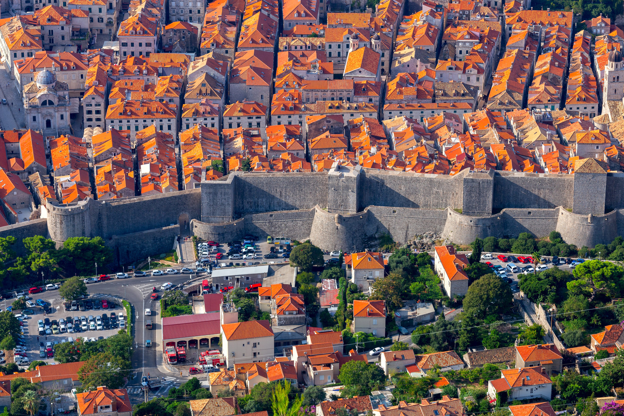 Dubrovnik's old town from above, terracotta roofs packed behind the land walls