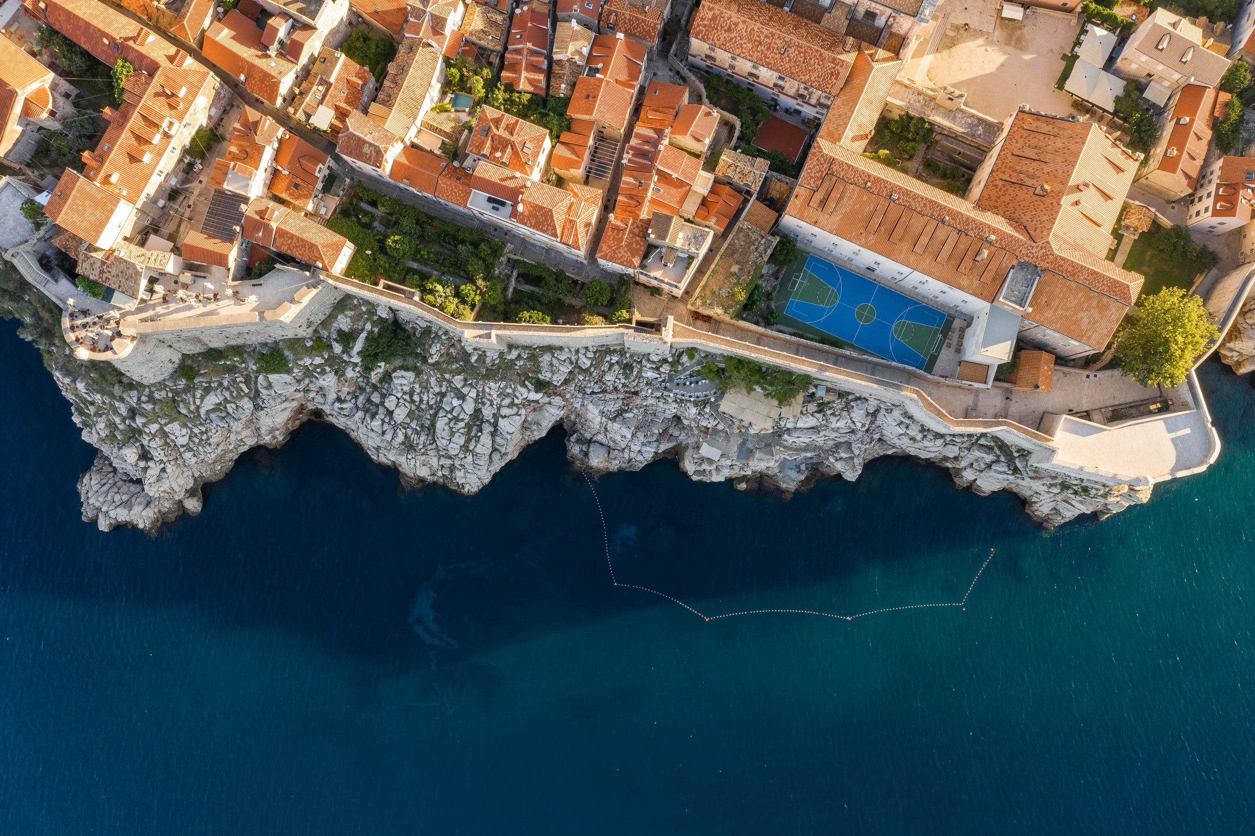 The city walls running along the cliff edge above the Adriatic in Dubrovnik