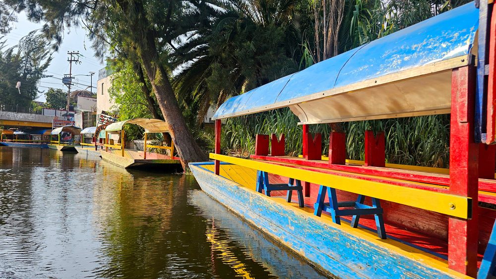 Painted trajinera boats moored along a canal at Xochimilco in southern Mexico City