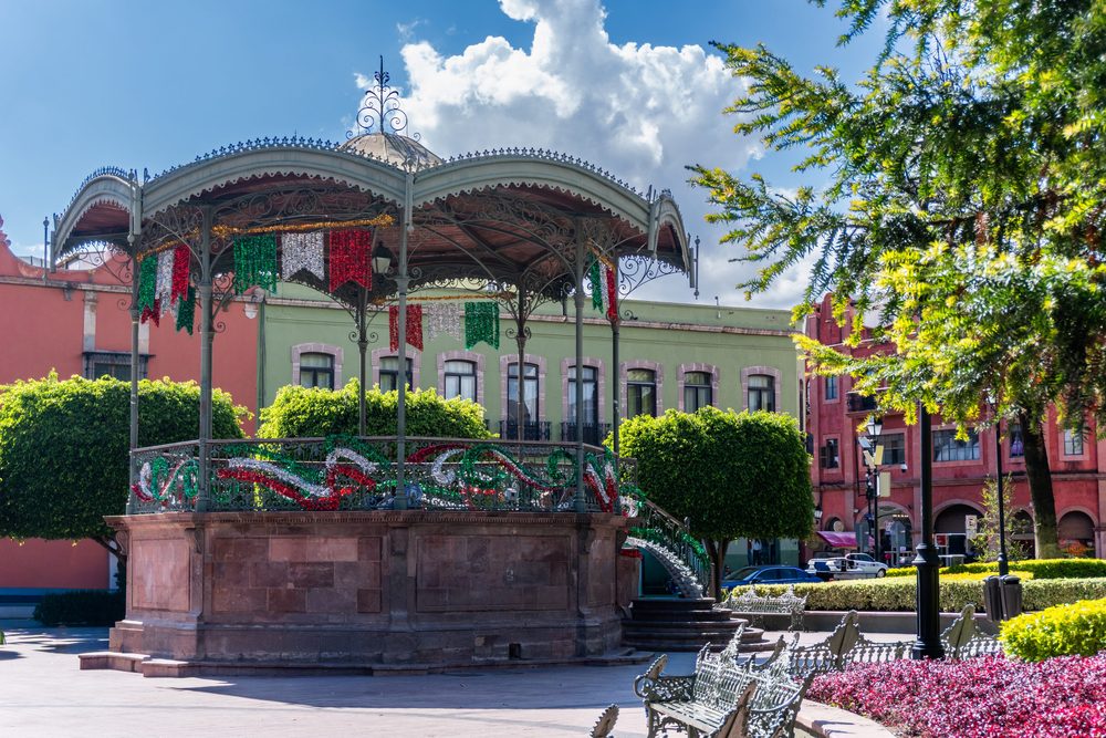 The cast-iron bandstand in Queretaro's historic centre, hung with green and red independence decorations