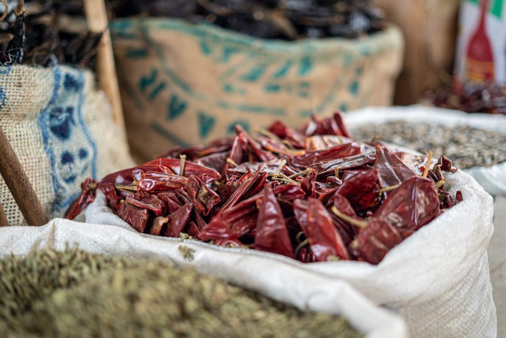 Sacks of dried red chillies and herbs on a Mexican market stall